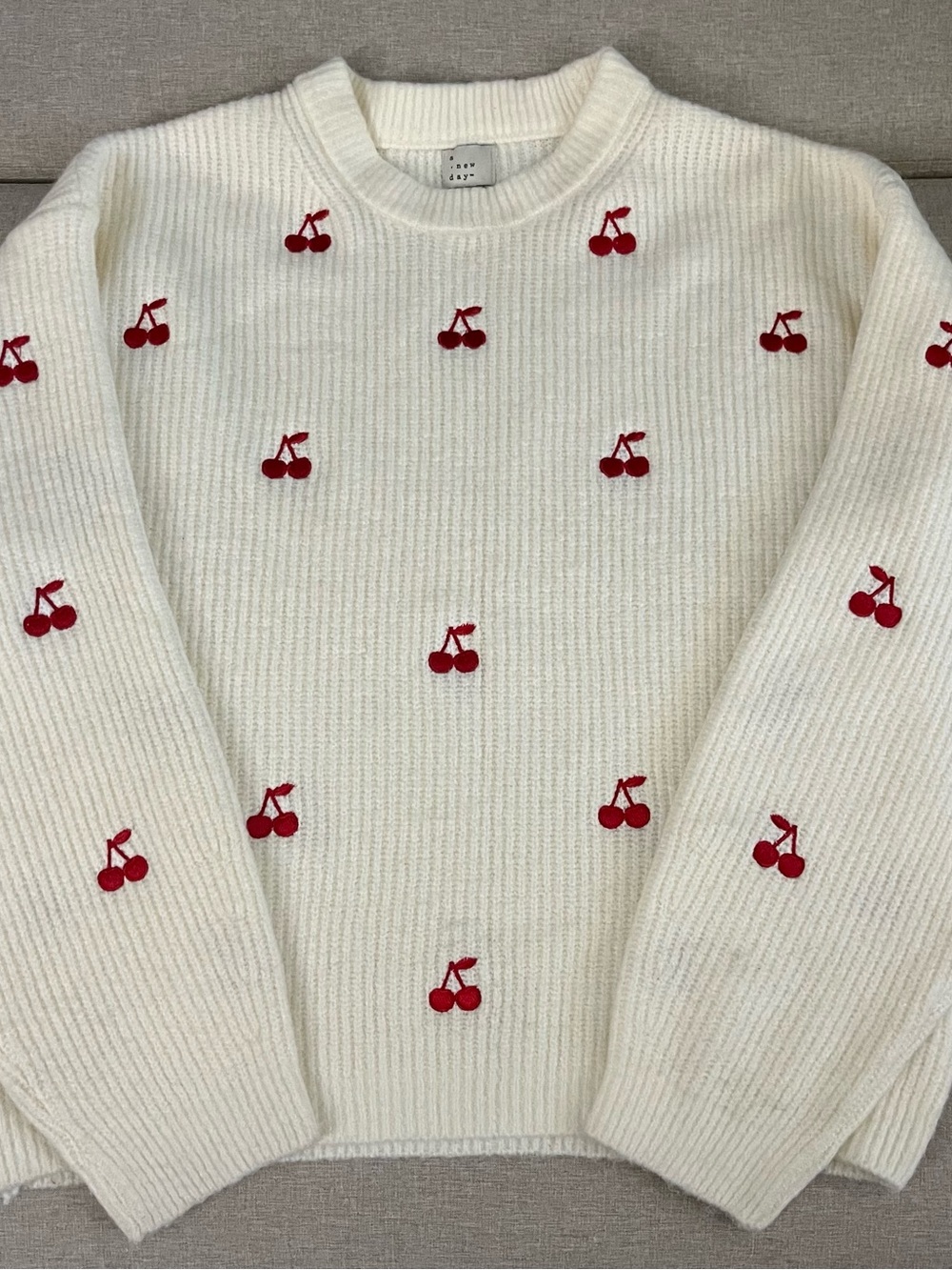 white sweater with red cherries embroidery